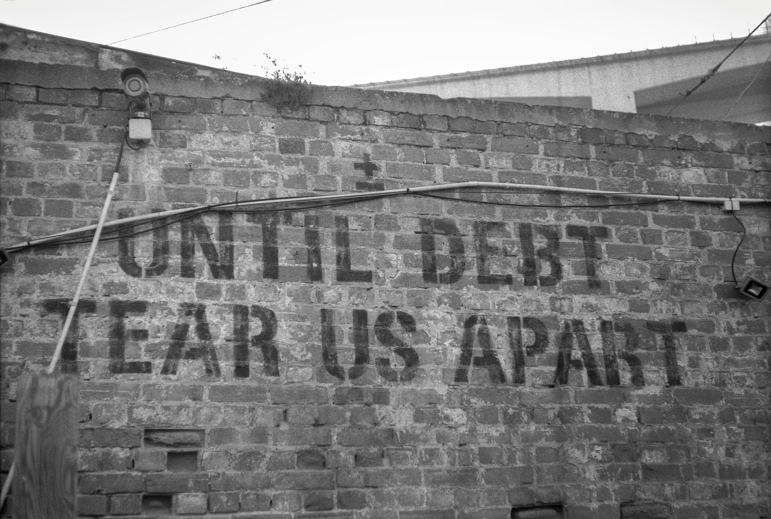 Before and after screenshots showing John's progress in reducing his total debt amount