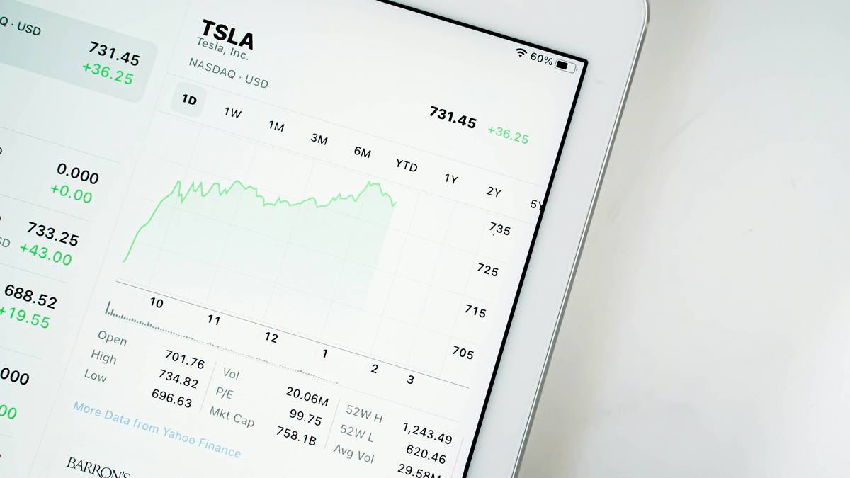 A small business owner working on a laptop at a cafe table